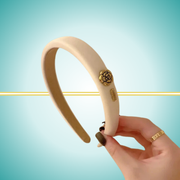 Elegant white headband featuring sophisticated gold metal rose detail