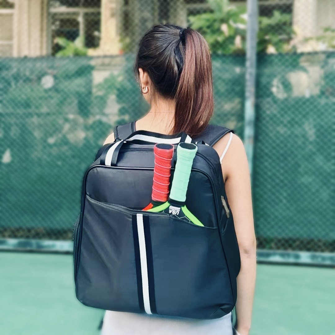 pickleball backpack featuring dedicated shoe compartment and convenient two-paddle capacity cover in front pocket black