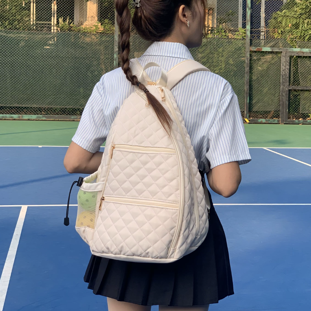 White puffer tennis convertible backpack for women with zipper transformation system - easily converts to sling bag while maintaining two-racket storage capacity