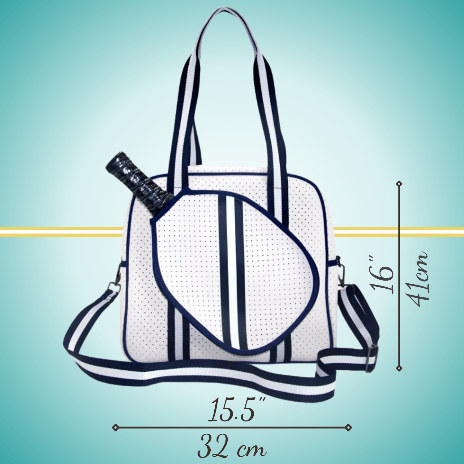 White women's pickleball tote bag with navy stripes, top handles, adjustable crossbody strap, and attached front paddle cover.